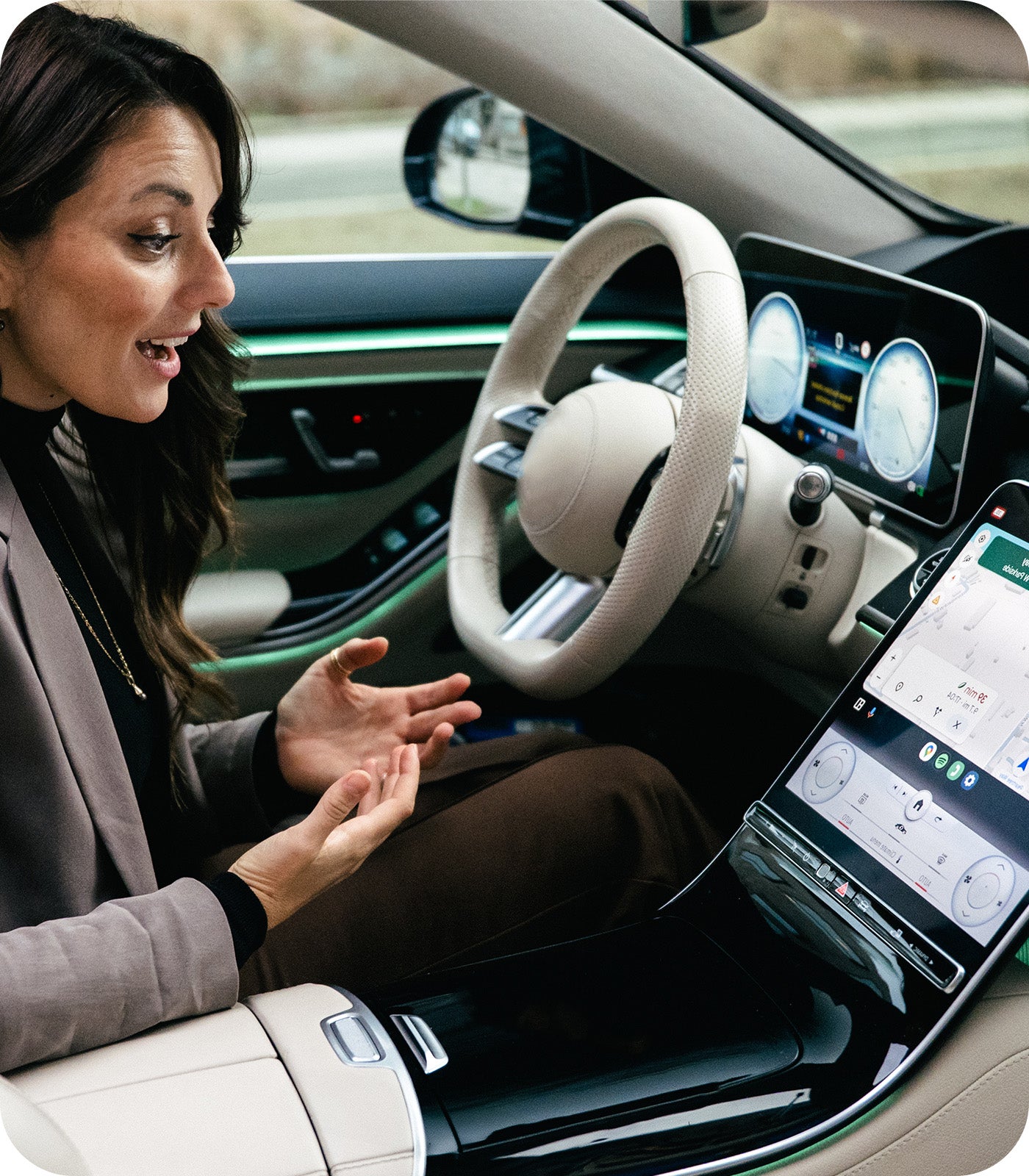 Driver using Ottocast CarPlay adapter with smart navigation on luxury car touchscreen display
