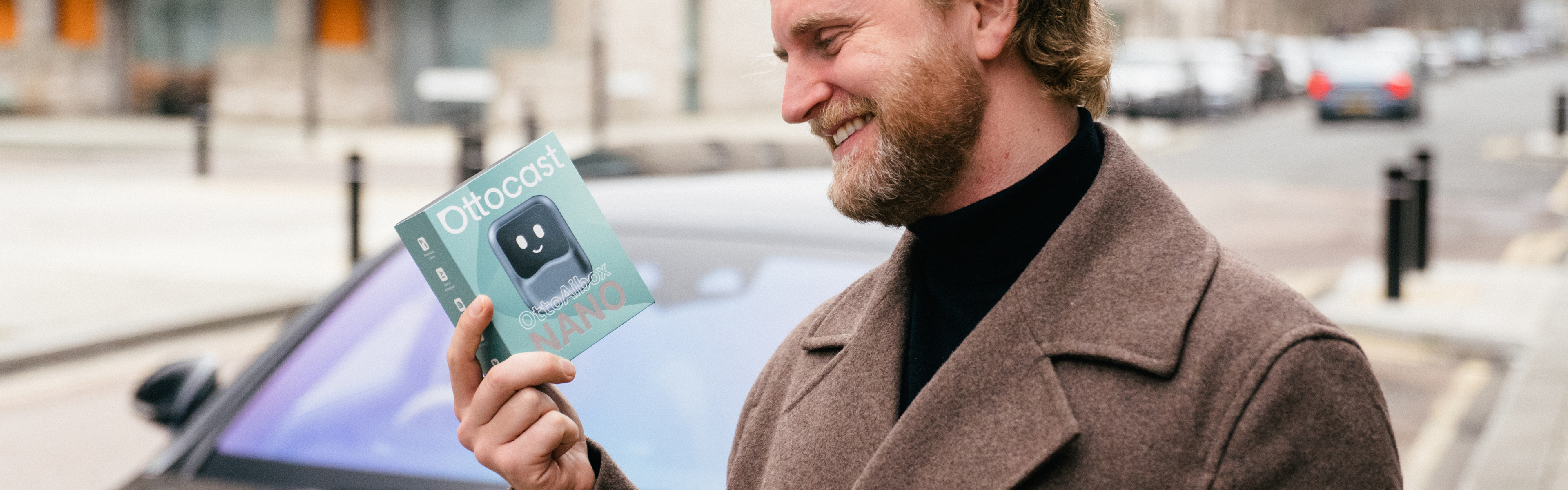 Man holding Ottocast Nano wireless CarPlay adapter box for easy Android Auto and iPhone connectivity