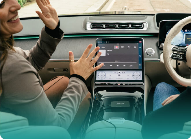 Passengers enjoying music with Ottocast Play2Video Pro wireless CarPlay Android Auto adapter on car dashboard screen